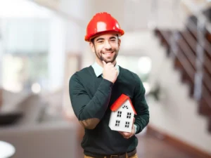 House building process Queensland - builder holding house model explaining construction stages