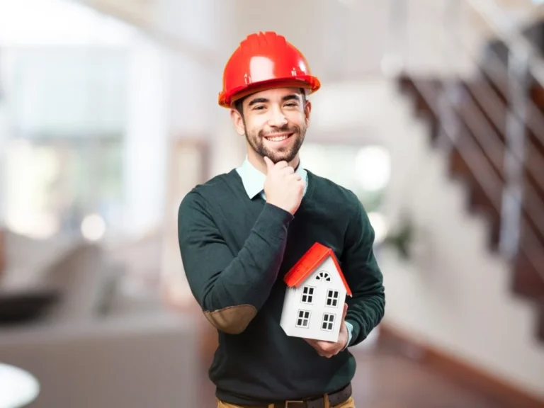 House building process Queensland - builder holding house model explaining construction stages
