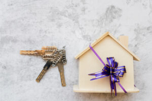 Renting vs buying in Brisbane - house keys and property model representing real estate decision