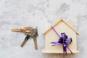 Renting vs buying in Brisbane - house keys and property model representing real estate decision