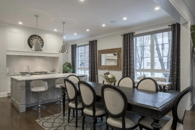 Open-plan kitchen and dining area with island bench, dining table and large windows
