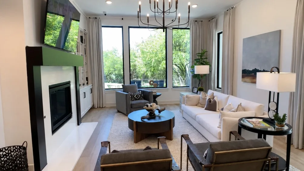 Modern living room with white sofa, fireplace, large windows and contemporary furnishings